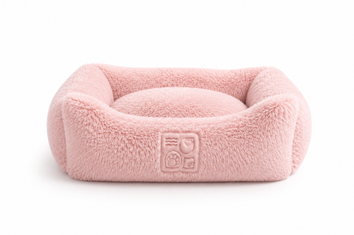 A plush pink pet bed with a soft fuzzy texture and embossed logo on the side